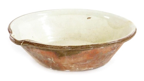 A large late 19thC terracotta pancheon, or dough bowl, with a cream glazed interior, 59cm wide.