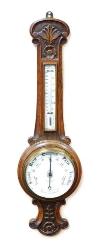 A Victorian oak cased wheel barometer by Winsor Bishop, Grantham, with aneroid barometer and thermometer, the case with floral and foliate engraving, 92cm high.