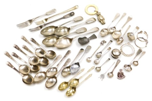 A George III silver caddy spoon, with engraved decorated, shield reserve initial engraved, William IV silver mustard spoon, London 1833, Georgian and later tea and salt spoons, pickle forks, pendant coil mounts, etc., 4.57oz, together with a group of plat