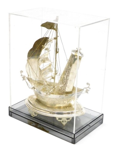 A Middle Eastern white metal model of a Dhow, converted to a table lamp, within a Perspex case, case 30cm x 22.5cm.