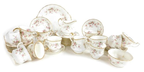 A Paragon porcelain Victoriana Rose pattern tea service, comprising bread plate, pair of cream jugs, sugar bowl, eleven teacups, twelve saucers and tea plates, together with a Duchess June Bouquet spoon dish.
