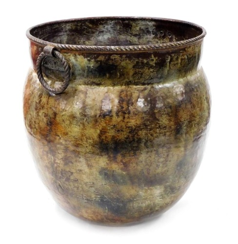 An Indian patinated copper pot, with double ring handles, 44cm high.