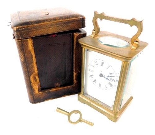 An early 20thC brass cased carriage clock, rectangular enamel dial bearing Roman numerals, single barrel movement, the case of conventional form, with key, 12cm high, together with a red Morocco leather outer case.