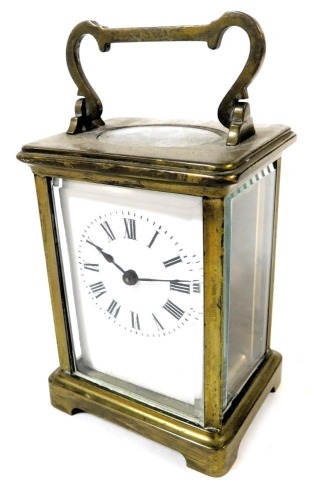 An early 20thC brass cased carriage clock, rectangular enamel dial bearing Roman numerals, single barrel movement, the case of conventional form, with key, 12cm high.