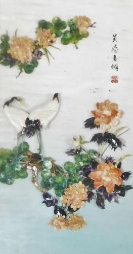 A late 20thC Chinese mother of pearl and hardstone picture, decorated in relief with cranes, flowers and blossom, painted four character and seal mark, framed and glazed, 71cm x 41cm.