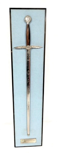 A Wilkinson's commemorative sword for the Battle of Britain, the wooden grip with a pommel embossed with the bust profile of Winston Churchill, above the winged eagle of the RAF, the blade engraved 'Dedicated to the Few and the Many who Helped make Victor