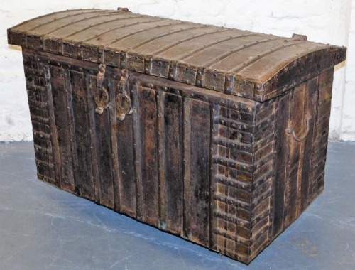 A wrought iron and steel sea chest, with rivet and studded finish, iron hinges and clasps to the lift dome top, chased finish decoration, 66cm high plus added wooden boards, 112cm wide, 64cm deep.