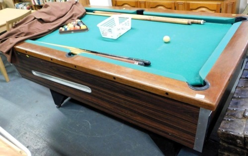 A slate bed mahogany framed pub pool table, with cues, balls, triangle, and cover.
