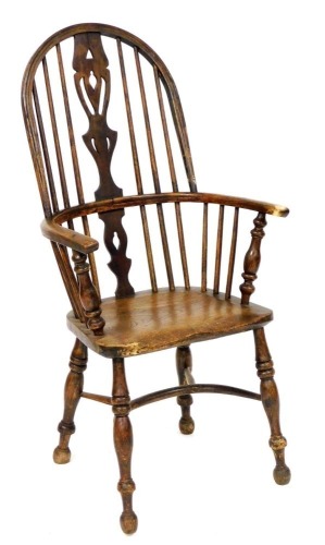 A 19thC oak and elm Windsor chair, with hoop back, pierced vase splat, solid saddle seat, raised on turned legs, united by a crinoline stretcher, 57cm wide.