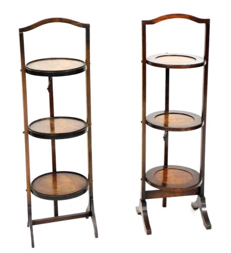 An early 20thC mahogany three tier folding cake stand, 91cm high, and an oak three tier folding cake stand, 91cm high. (2)