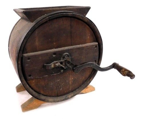 A late 19thC oak butter churn, of barrel form, with a cast iron handle, 43cm high, 39cm wide.