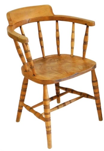 A Victorian beech and elm captain's chair, with a solid saddle seat, raised on turned legs united by a double H frame stretcher, 57cm wide.
