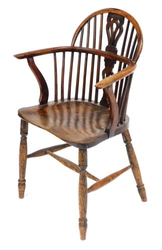 A 19thC yew and elm Windsor chair, with a vase shaped carved splat, solid saddle seat, raised on turned legs united by an H frame stretcher, 57cm wide.