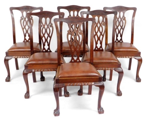 A set of six early 20thC Chippendale style mahogany single dining chairs, with leatherette drop in seats, raised on cabriole legs and ball and claw feet.