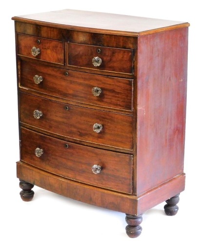 A Victorian mahogany bow front chest of two short over three long drawers, with moulded glass handles, raised on turned feet, 117cm high, 93cm wide, 53cm deep.