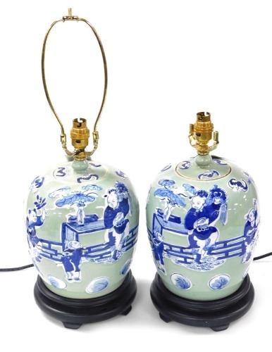 A pair of Chinese blue and white jar and cover table lamps, decorated with figures against a celadon ground, 37cm high. Buyer Note: WARNING! This lot contains untested or unsafe electrical items. It is supplied for scrap or reconditioning only. TRADE ONL