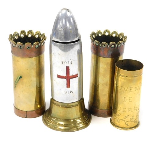 A WWI brass and alloy 'shell head' Red Cross money box, 17cm high, a brass trench art shell case souvenir de guerre, 5cm, and a pair of heavy brass and copper mounted shell case vases, 12cm high.