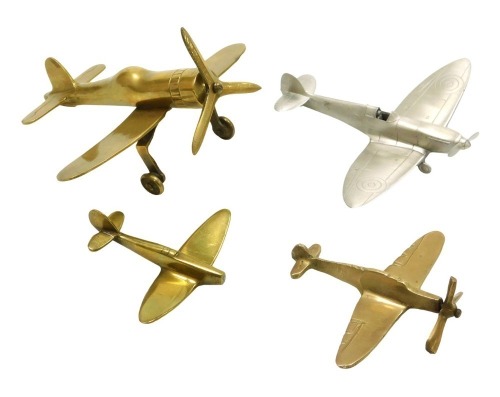 A brass model monoplane, and three other model aircraft, two brass including a miniature spitfire and a Franklin Mint model spitfire. (4)