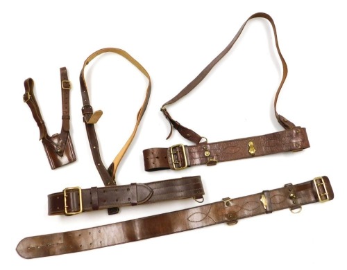 Two British Army Sam Browne leather belts, with shoulder straps, a sword frog, and another Sam Browne belt. (4)