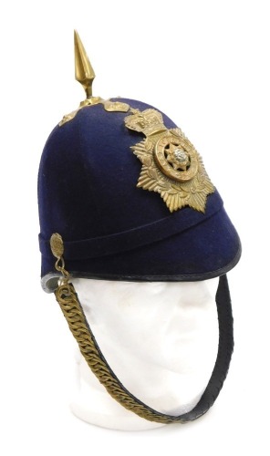 An early 20thC British Army blue cloth helmet, with East Yorkshire Regiment brass badge and chin strap.