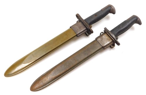 Two American WWII M1 Garand bayonets, both with 24.5cm blades, one stamped UC US, lacking muzzle ring, both with scabbards.