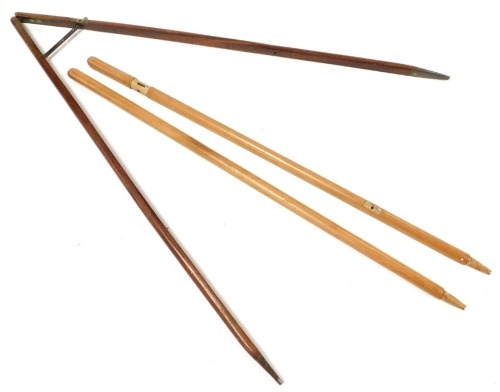 Two parade ground pace sticks, one in mahogany with brass fittings, the other in beech and labelled 'for CS 1982' with broad arrow insignia, incomplete.