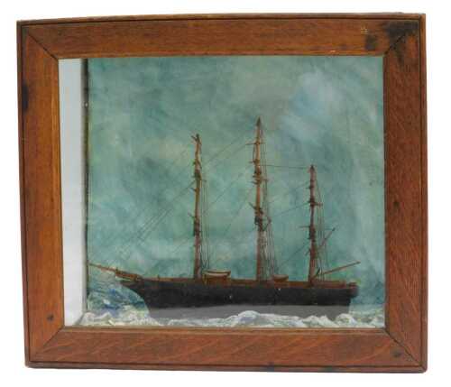 A 19thC model of a tea clipper, on painted waves, contained in an oak and glass case, 32cm x 36.5cm.