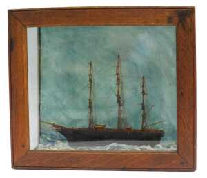 A 19thC model of a tea clipper, on painted waves, contained in an oak and glass case, 32cm x 36.5cm.