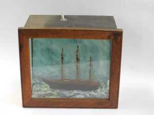 A 19thC model of a tea clipper, on painted waves, contained in an oak and glass case, 32cm x 36.5cm. - 2