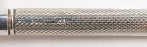 A silver cased propelling pencil, with engine turned decoration, together with a Yard O' Lead metal cased ball point pen and a Unoargento Italian ball point pen, marked 925. - 5