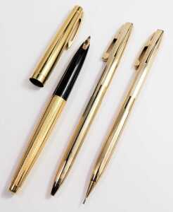 A Sheaffer fountain pen, in gold coloured part engine turned casing, 14ct nib, boxed, together with a Sheaffer ball point and pencil two piece set, in gold coloured ribbed casing, boxed. - 2