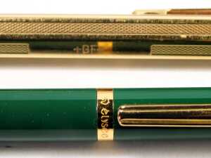 A Caran d'Ache ball point pen, in gold coloured engine turned decoration, together with an Elysee two pen set, in green, and two Sheaffer ball point pens. - 3