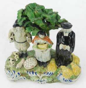 An early 19thC Staffordshire pottery figure group, modelled as The Tithe Pig Group, 17cm high. (AF) - 2