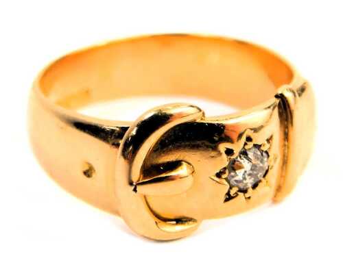 A Victorian 18ct gold buckle ring, the raised buckle design inset with round brilliant cut diamond, star set, approx 0.25ct, Birmingham 1888, ring size V&frac12;, 10.7g all in.