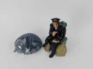 A Royal Doulton porcelain figure, modelled as Shore Leave HN2254, and a Royal Copenhagen porcelain figure of a seated and curled cat, 12cm wide. (2) - 2
