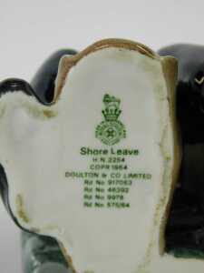 A Royal Doulton porcelain figure, modelled as Shore Leave HN2254, and a Royal Copenhagen porcelain figure of a seated and curled cat, 12cm wide. (2) - 4