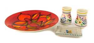 Four items of Poole pottery, comprising a Poole Delphis charger on an orange ground, 27cm wide, two circa 1960s Poole bud vases, 8cm high, and an ashtray with floral centre, 11cm wide. (4)