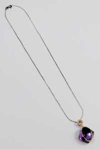 An 18ct gold amethyst and diamond pendant, on a silver chain. - 4