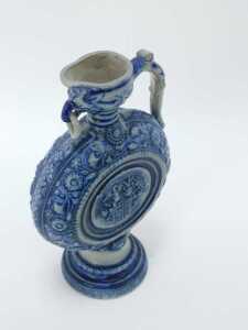 A Westerwald salt glazed jug, on a blue and grey patterned ground, with shield, 29cm high. - 3