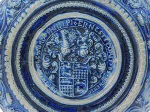 A Westerwald salt glazed jug, on a blue and grey patterned ground, with shield, 29cm high. - 4