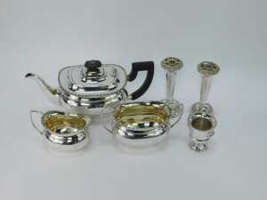 A silver plated three piece tea set, comprising teapot, milk jug, sugar bowl, each with a beaded border and ebonised handle, a pair of silver plated stem vases and a miniature Campana urn. (6) - 2