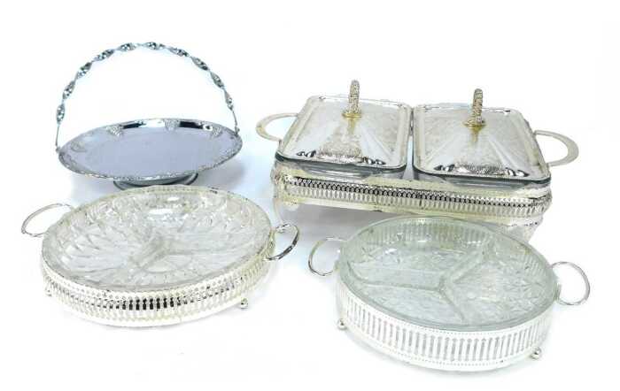 A group of silver plated table wares, comprising a two piece breakfast server, with glass inserts and silver plated rim, 11cm high, 30cm wide, two glass and silver rimmed serving dishes, 21cm wide, and a silver plated and berry design with swing handle, 2