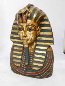 Three Egyptian related items, comprising a wooden pharaoh head, overpainted in gilt, 68cm high, 41cm wide, a sphinx style cat, 45cm high, and an Egyptian sarcophagus display case, 130cm high, 34cm wide, 28cm deep. - 6