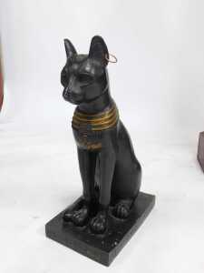 Three Egyptian related items, comprising a wooden pharaoh head, overpainted in gilt, 68cm high, 41cm wide, a sphinx style cat, 45cm high, and an Egyptian sarcophagus display case, 130cm high, 34cm wide, 28cm deep. - 7