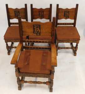 A set of four 20thC oak armchairs, comprising carver and three singles, each with carved and raised back bearing initials/shield possibly H, with later cushions. (4) - 2