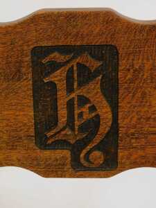 A set of four 20thC oak armchairs, comprising carver and three singles, each with carved and raised back bearing initials/shield possibly H, with later cushions. (4) - 5