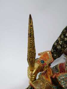 Two South East Asian wooden puppets, each with embroidered cloth, and gilt overpainted wooden heads and feet, on string supports. (2) - 4