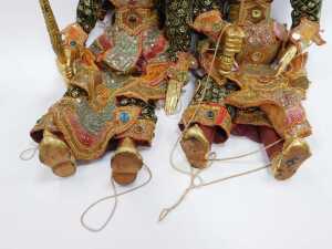Two South East Asian wooden puppets, each with embroidered cloth, and gilt overpainted wooden heads and feet, on string supports. (2) - 5