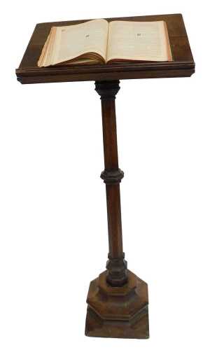 A Victorian oak lectern, the box sloped top raised on an octagonal column and base, 160cm high, 70cm wide, 32cm deep, together with a Churchman's Family Bible New Testament with commentary. (2) (AF)