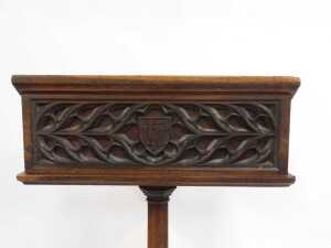 A Victorian oak lectern, the box sloped top raised on an octagonal column and base, 160cm high, 70cm wide, 32cm deep, together with a Churchman's Family Bible New Testament with commentary. (2) (AF) - 6